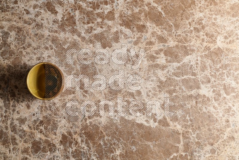 Top View Shot Of A Multicolored Pottery cup On beige Marble Flooring