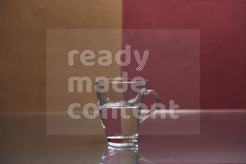 The image features a clear glassware filled with water, set against brown and dark red background