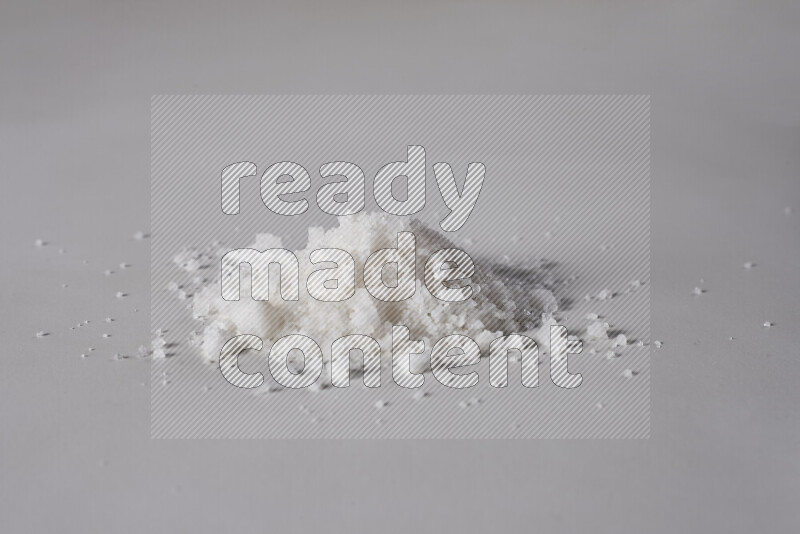 A bunch of coarse sea salt crystals on white background