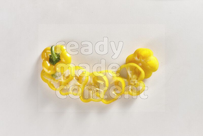 Yellow bell pepper slices on white background