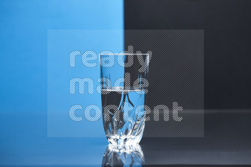 The image features a clear glassware filled with water, set against blue and black background