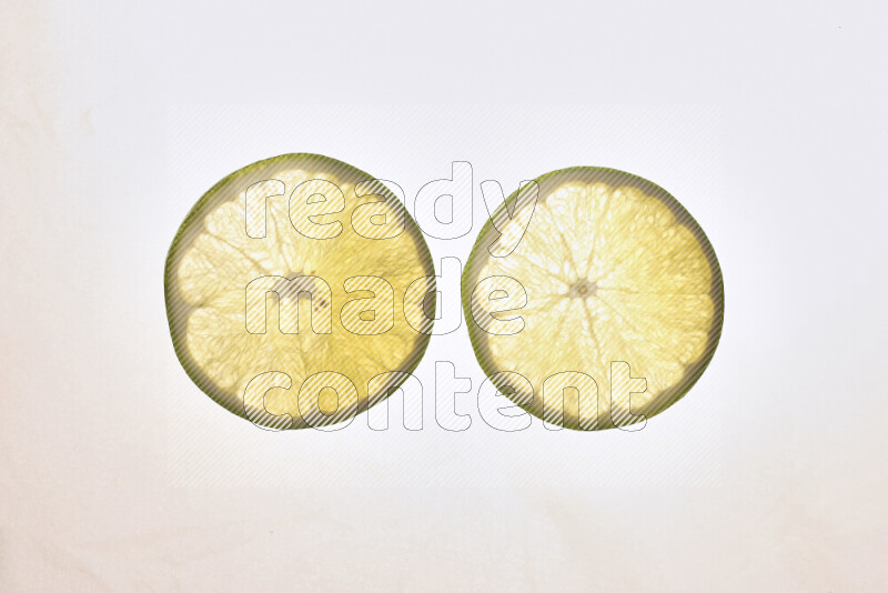 Orange slices on illuminated white background