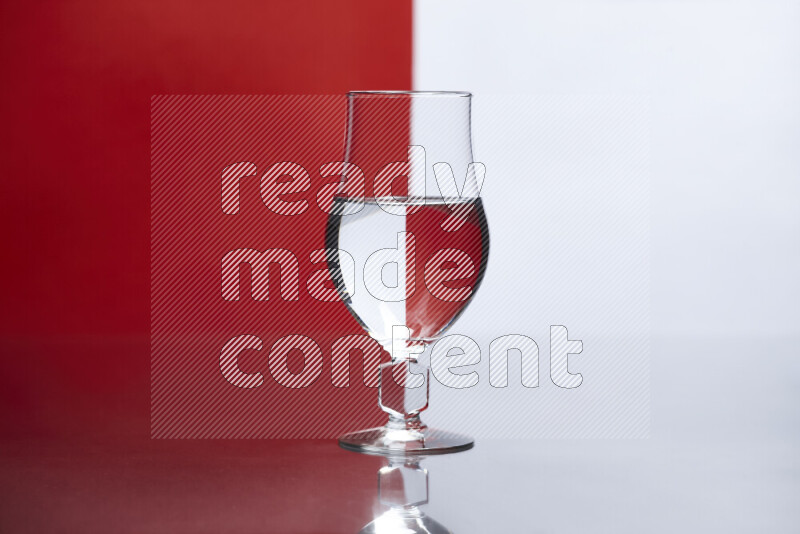 The image features a clear glassware filled with water, set against white and red background