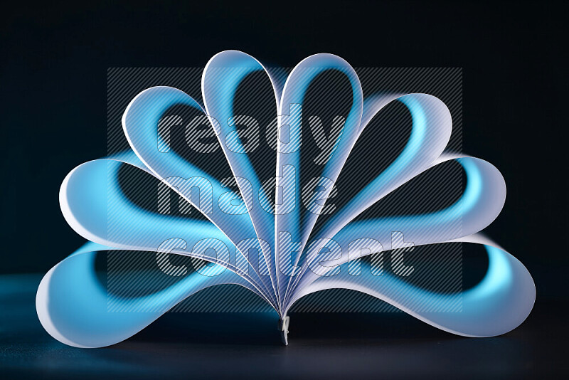 An abstract art piece displaying smooth curves in blue gradients created by colored light