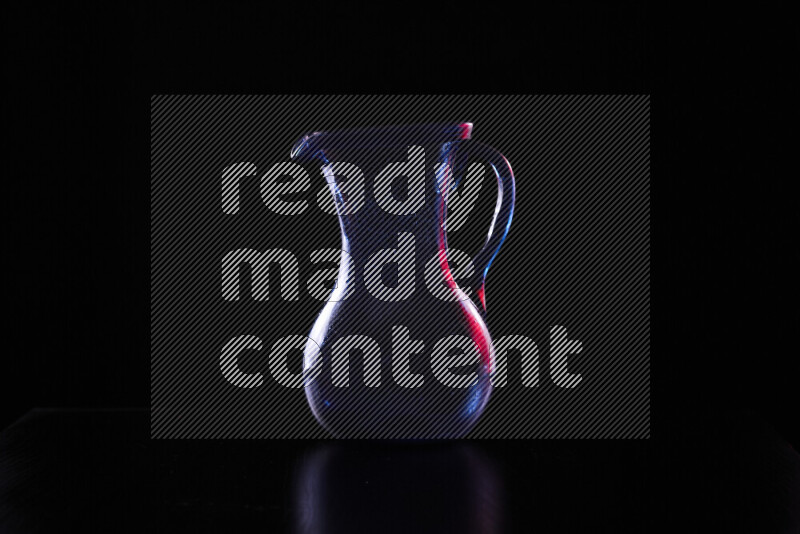 Glassware with rim light in red and white against black background