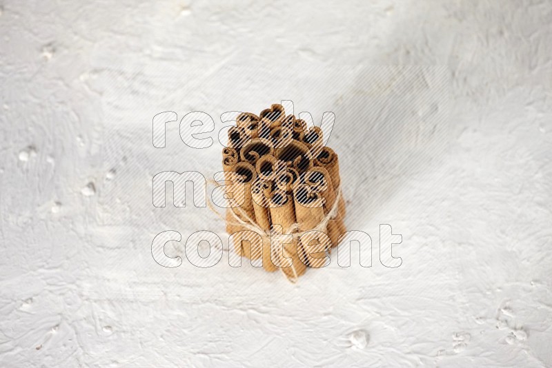 A bounded stack of cinnamon sticks on white background