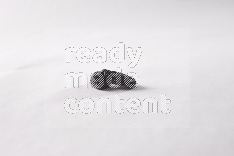 Dried plums on white background