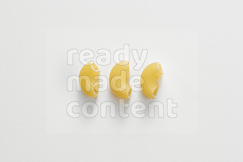 Elbow pasta on white background