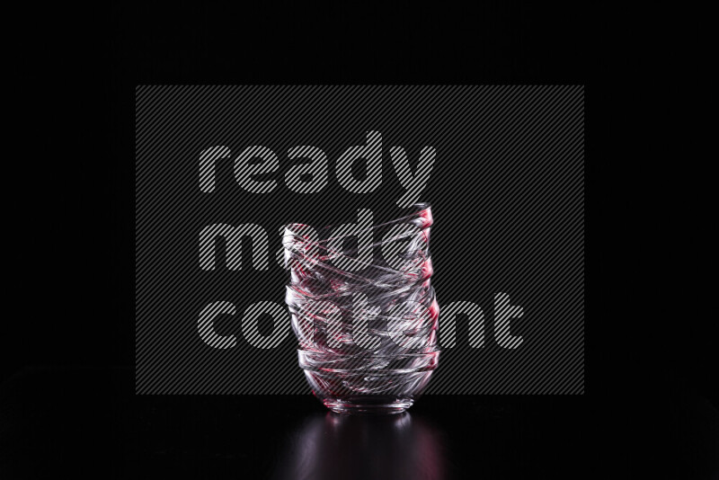 Glassware with rim light in red and white against black background