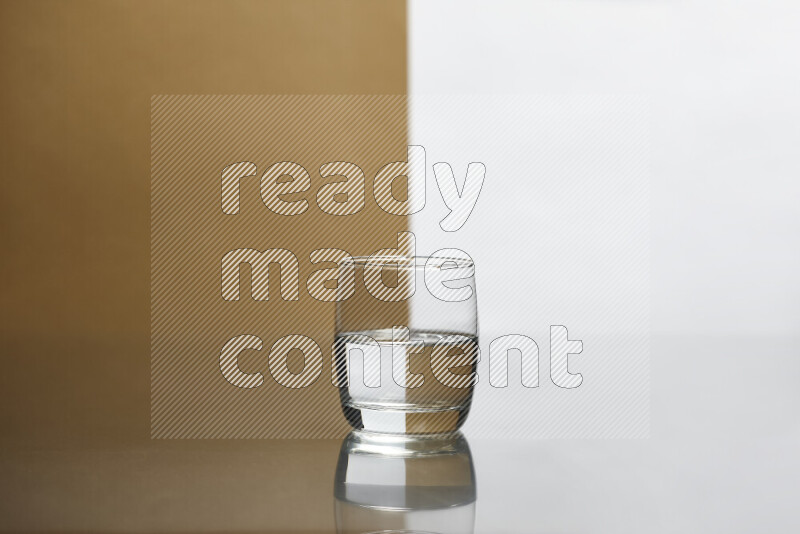 The image features a clear glassware filled with water, set against white and beige background