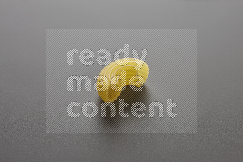 Elbow pasta on grey background