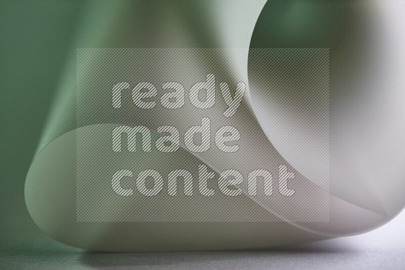 فن تجريدي يعرض منحنيات وتدرجات اللون الأخضر والرمادي مكونه بضوء ملون