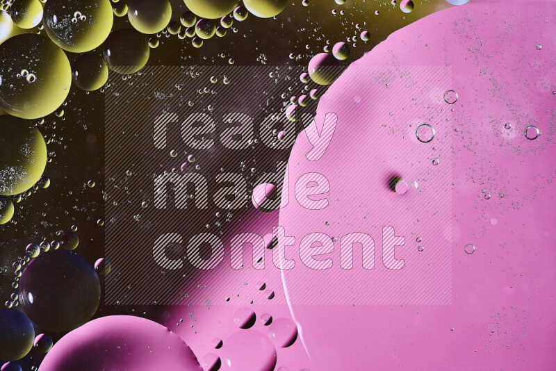 Close-ups of abstract oil bubbles on water surface in shades of yellow, pink and black