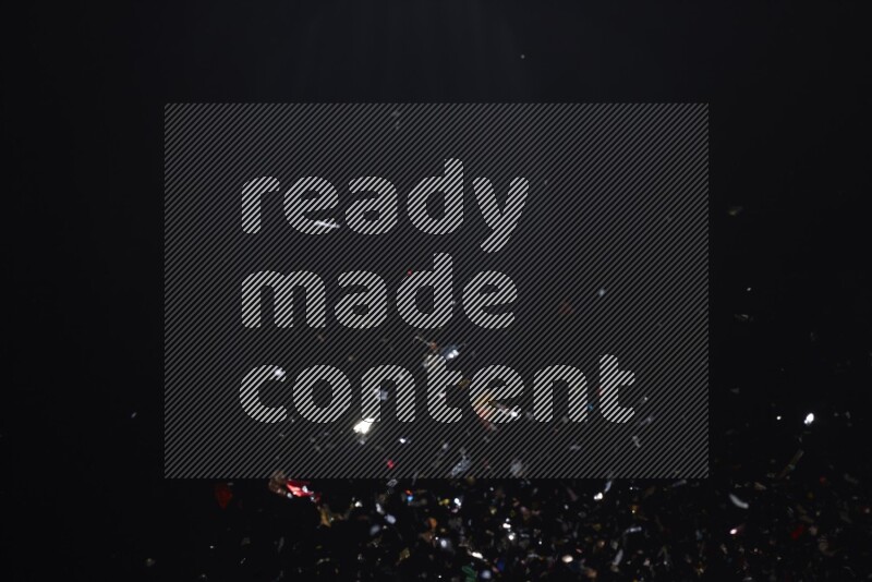Falling multicolored confetti on black background