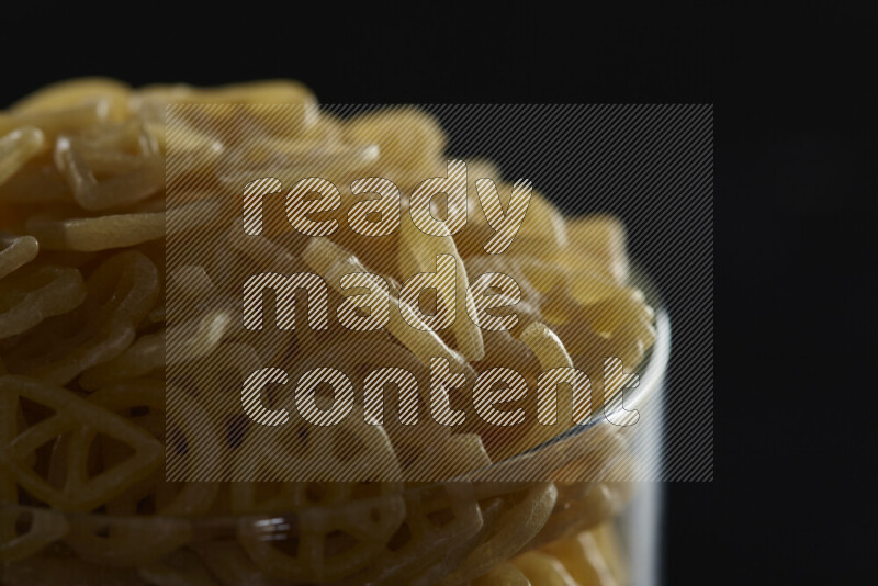 Snacks in a glass jar on black background