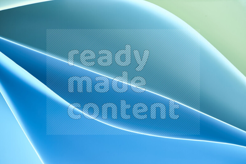 هذه الصورة تعرض تكوين فن الورق التجريدي مع منحنيات ورقية بتدرجات اللون الأخضر والأزرق المكونه بواسطة الضوء الملون