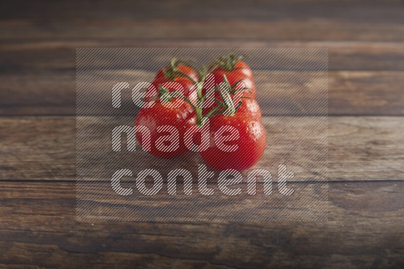 Red cherry tomato vein on a textured wooden background 45 degree
