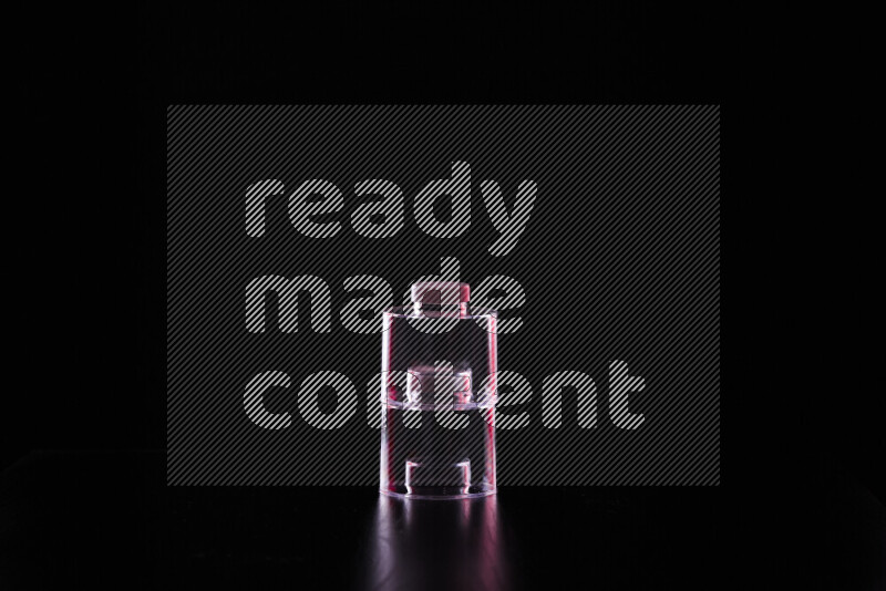 Glassware with rim light in red and white against black background