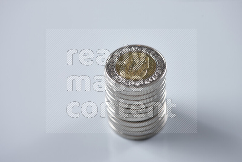Stack Egyptian one pound coins on grey background