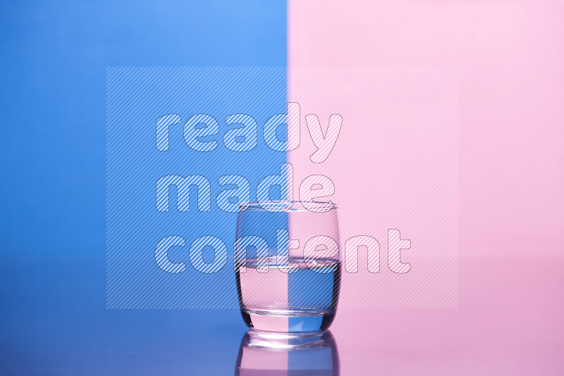 The image features a clear glassware filled with water, set against blue and rose background