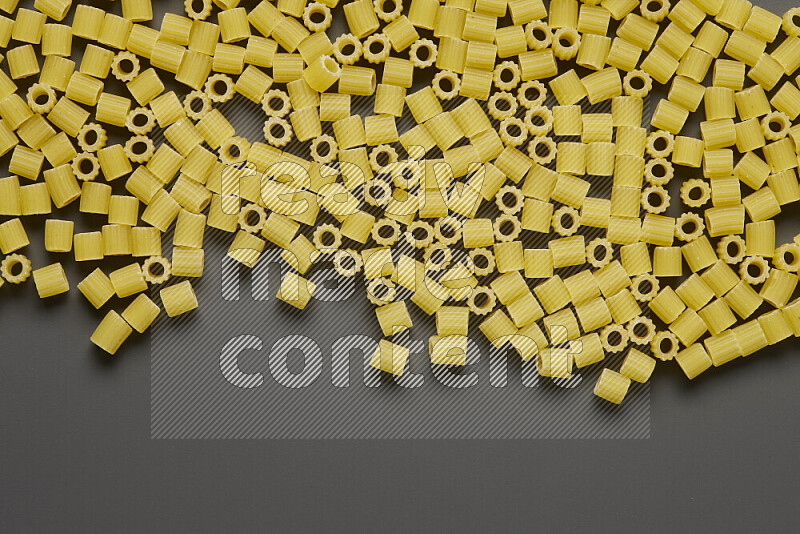 Small rings pasta on grey background