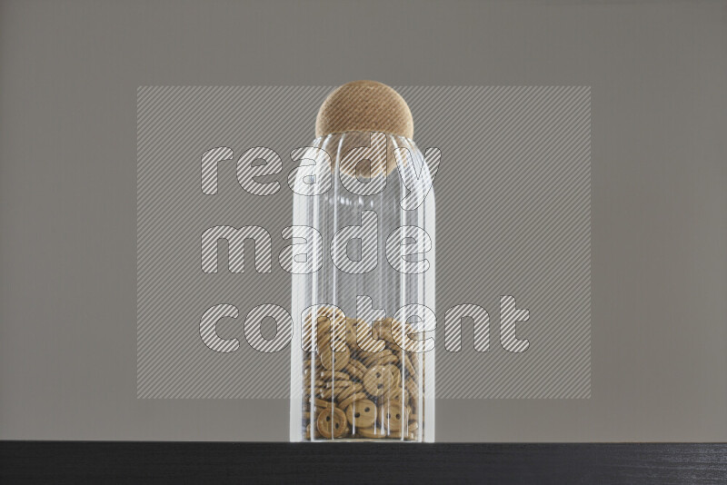 Buttons in a glass jar on black background