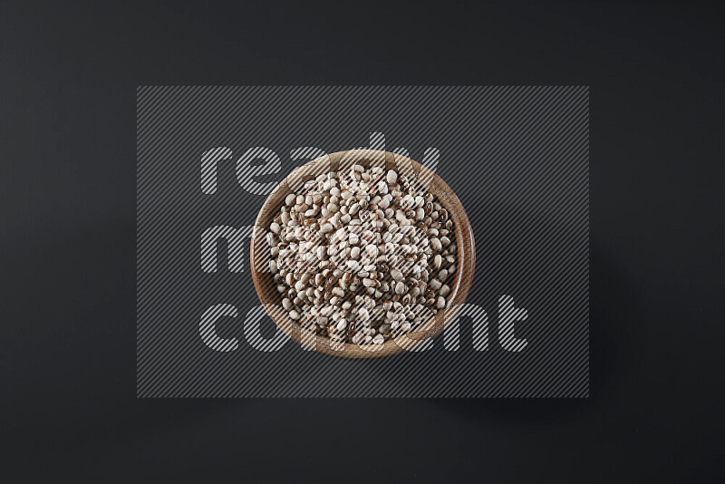 Black-eyed peas in a wooden bowl on grey background