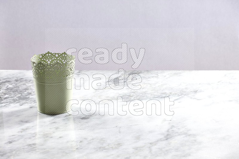 An Empty Light Green Plant Pot on light grey Marble Flooring 45 degree angle