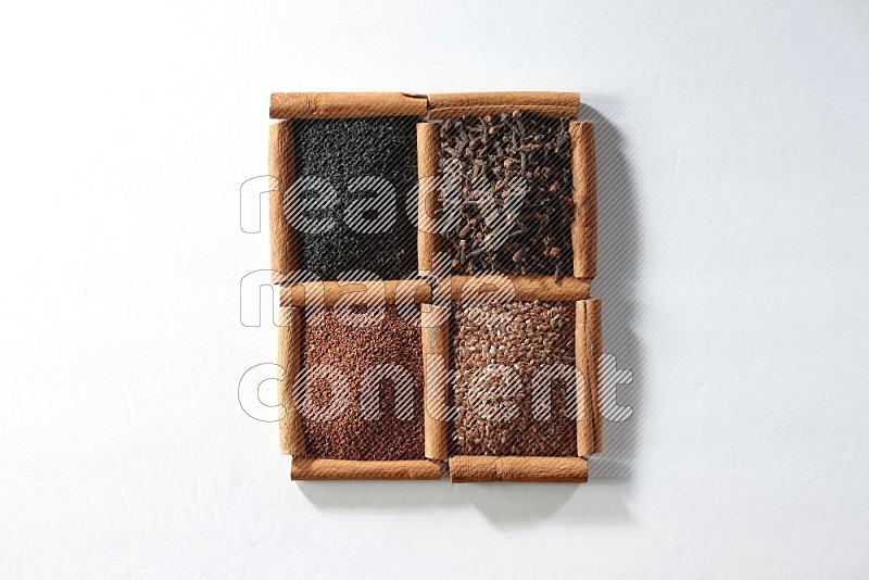 4 squares of cinnamon sticks full of black seeds, cloves, flaxseeds and garden cress on white flooring