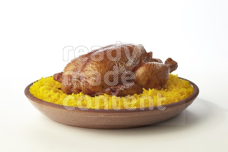 yellow basmati Rice with whole roasted chicken  on a pottery plate  direct  on white background