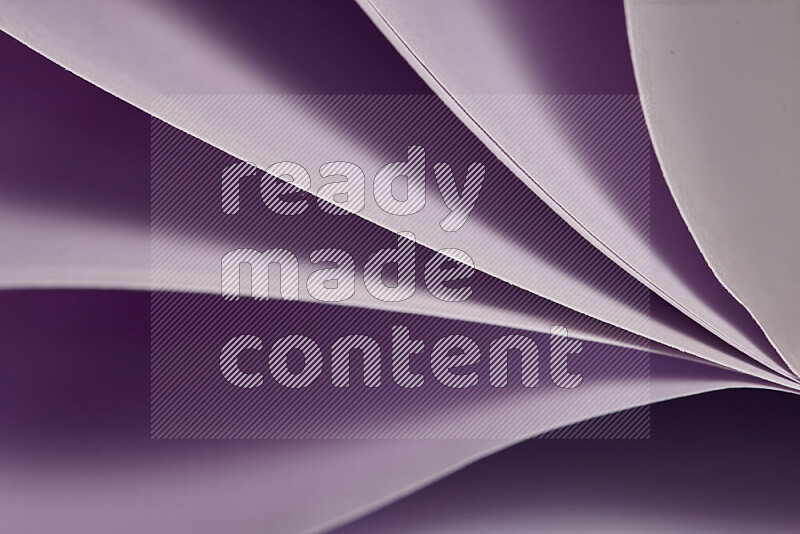 An abstract art showing purple paper sheets arranged in an overlapping curves