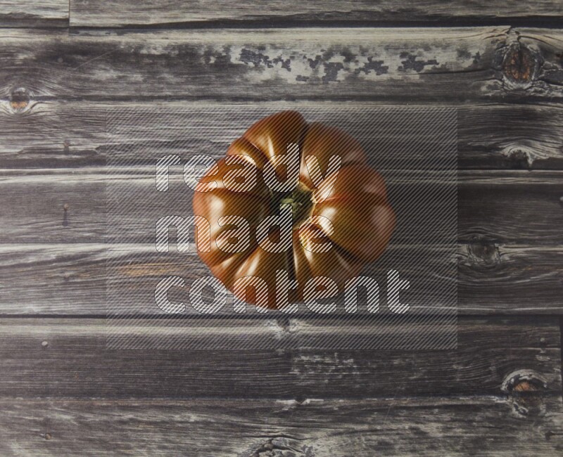 Single Tipview Heirloom Tomato on grey wooden background