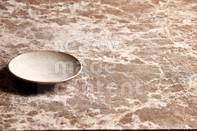 Beige Pottery Plate on Beige Marble Flooring, 45 degrees