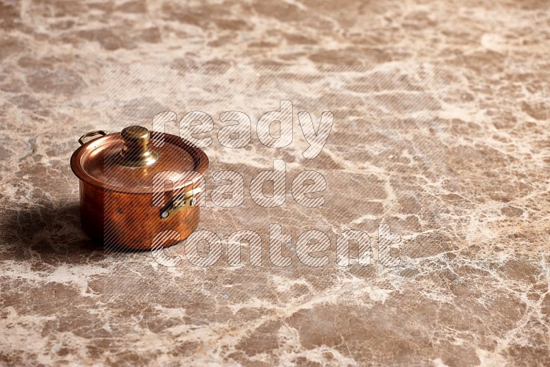 Small Copper Pot on Beige Marble Flooring, 45 degrees