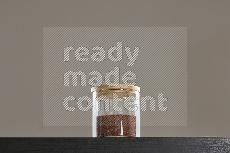 Garden cress in a glass jar on black background
