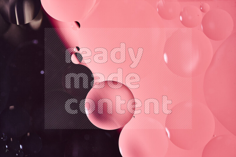 Close-ups of abstract oil bubbles on water surface in shades of black and pink