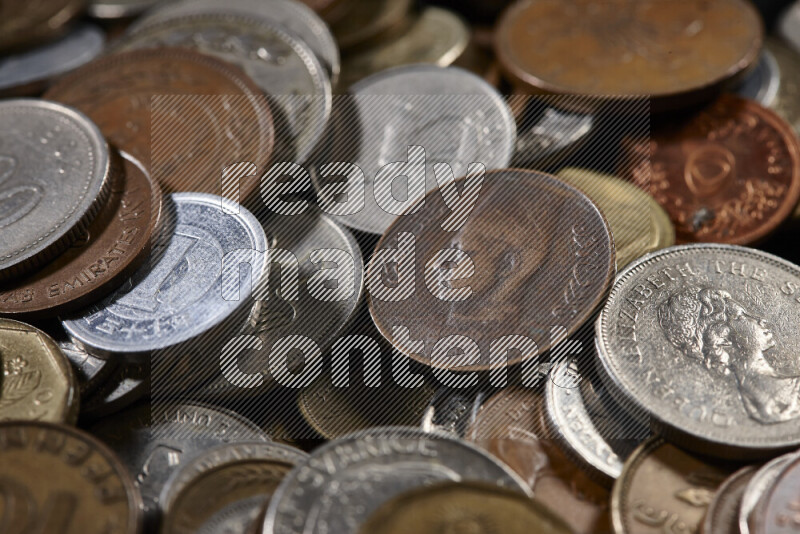 A close-ups of random old coins on black background