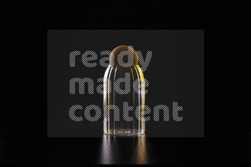 Glassware with rim light in yellow and white against black background