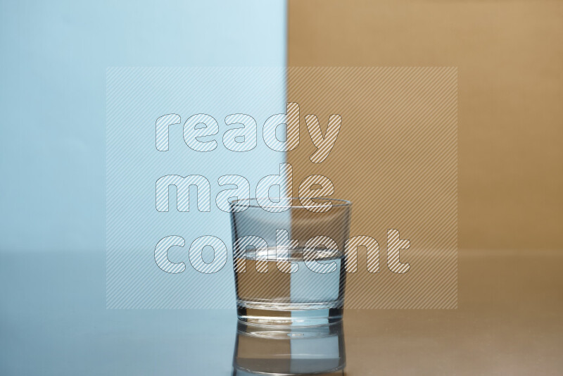 The image features a clear glassware filled with water, set against light blue and beige background