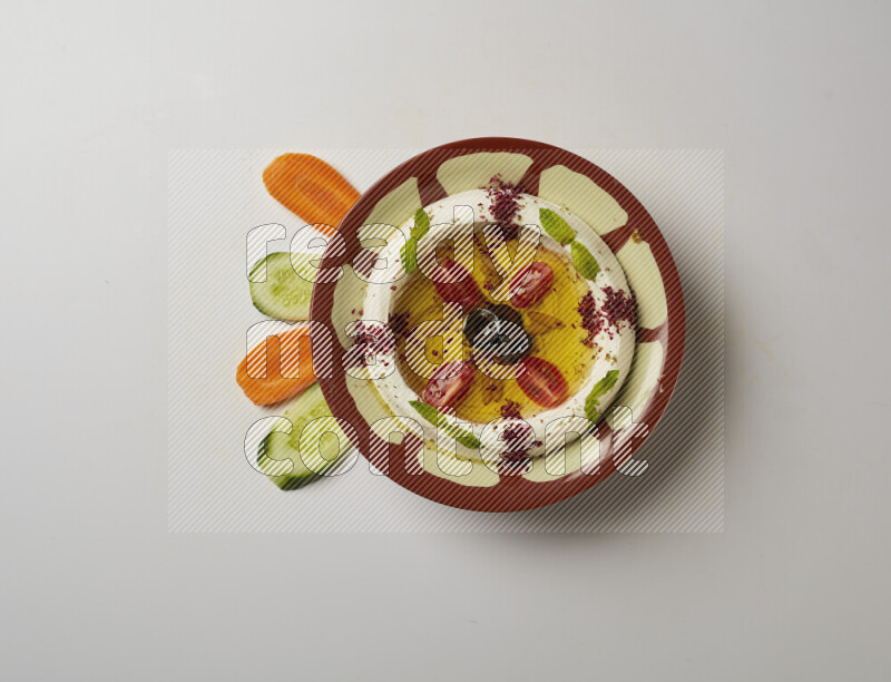 Lebnah garnished with Cherry tomato, mint & sumak  in a traditional plate on a white background