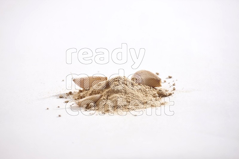 Garlic powder and garlic bulb and cloves on a white flooring in different angles