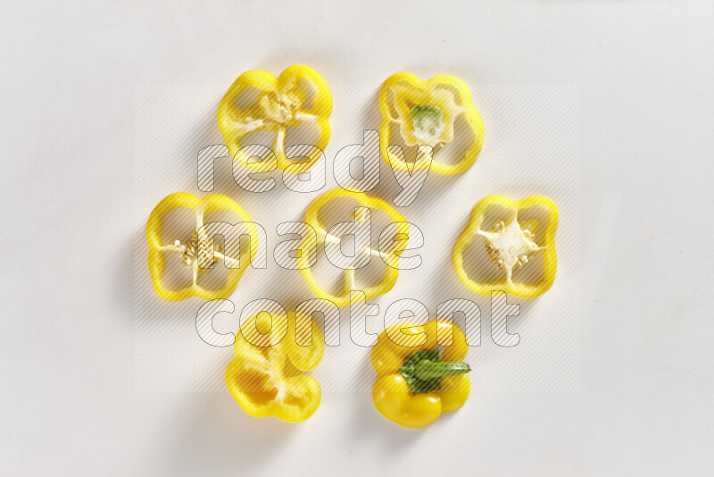 Yellow bell pepper slices on white background