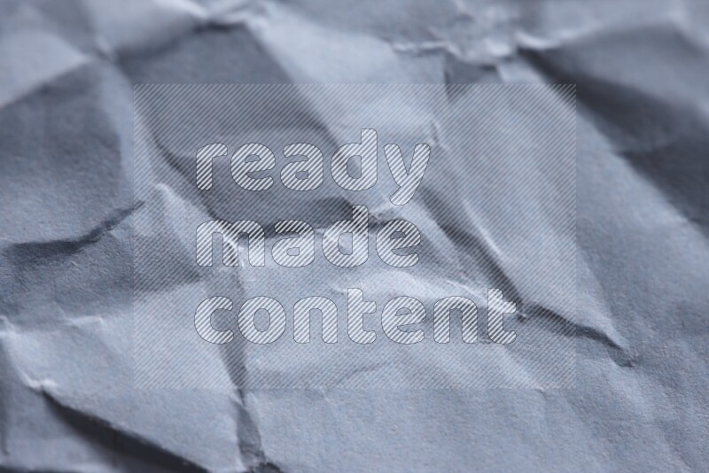 Crumpled craft paper on black background