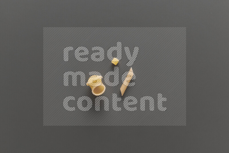 Different pasta types on grey background