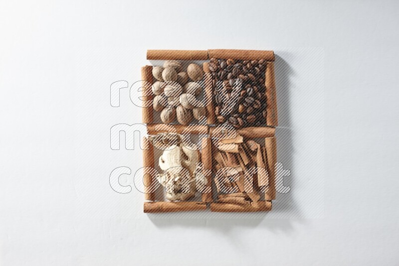 4 squares of cinnamon sticks full of coffee beans, nutmeg, cinnamon and dried ginger on white flooring