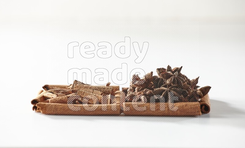 2 squares of cinnamon sticks full of star anise and cinnamon on white flooring