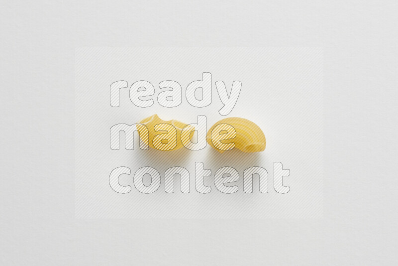 Elbow pasta on white background