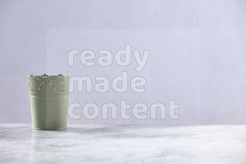 An empty green plant pot on grey marble background