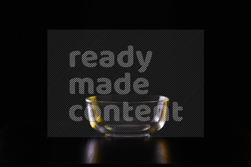 Glassware with rim light in yellow and white against black background