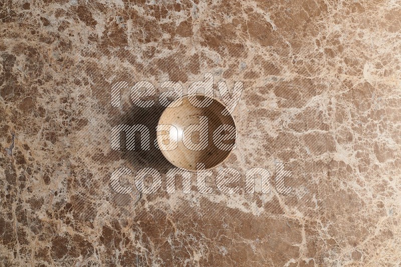 Top View Shot Of A Beige Pottery bowl On beige Marble Flooring